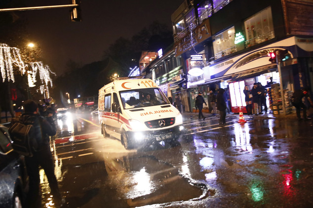 An ambulance rushes from the scene of an attack in Istanbul, early Sunday, Jan. 1, 2017. Turkey's state-run news agency said an armed assailant has opened fire at a nightclub in Istanbul during New Year's celebrations. (AP Photo/Halit Onur Sandal)