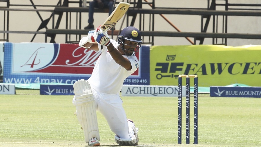 Sri Lanka batsman Dimuth Karunaratne plays a shot during the test cricket match against Zimbabwe at Harare Sports Club in Harare, Sunday, Nov, 6, 2016. Zimbabwe is playing its 100th test cricket match as it hosts Sri Lanka in Zimbabwe. (AP Photo/Tsvangirayi Mukwazhi)