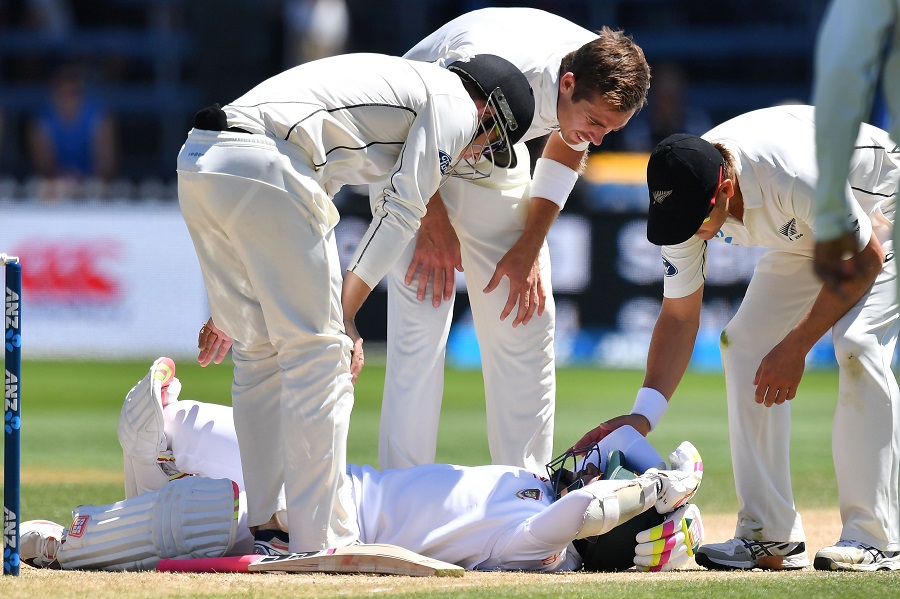 Bangladesh's Mushfiqur Rahim is checked by New Zealand's Tom Latham (L), Tim Southee (C) and Neil Wagner (R) after Rahim was hit in the head during day five of the first international Test cricket match between New Zealand and Bangladesh at the Basin Reserve in Wellington on January 16, 2017.  / AFP / Marty Melville        (Photo credit should read MARTY MELVILLE/AFP/Getty Images)